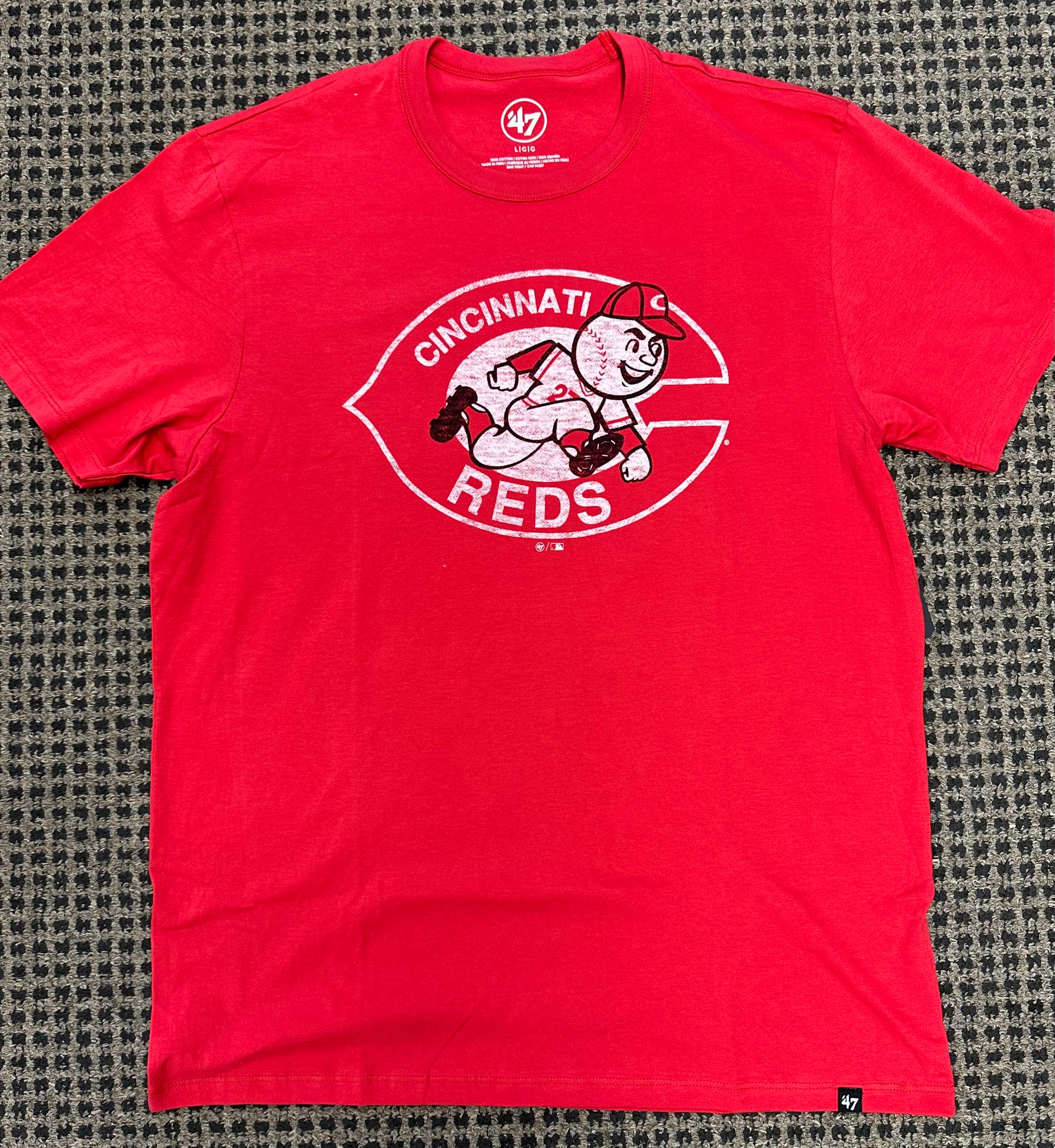 on floor, red shirt, reds team shirt
