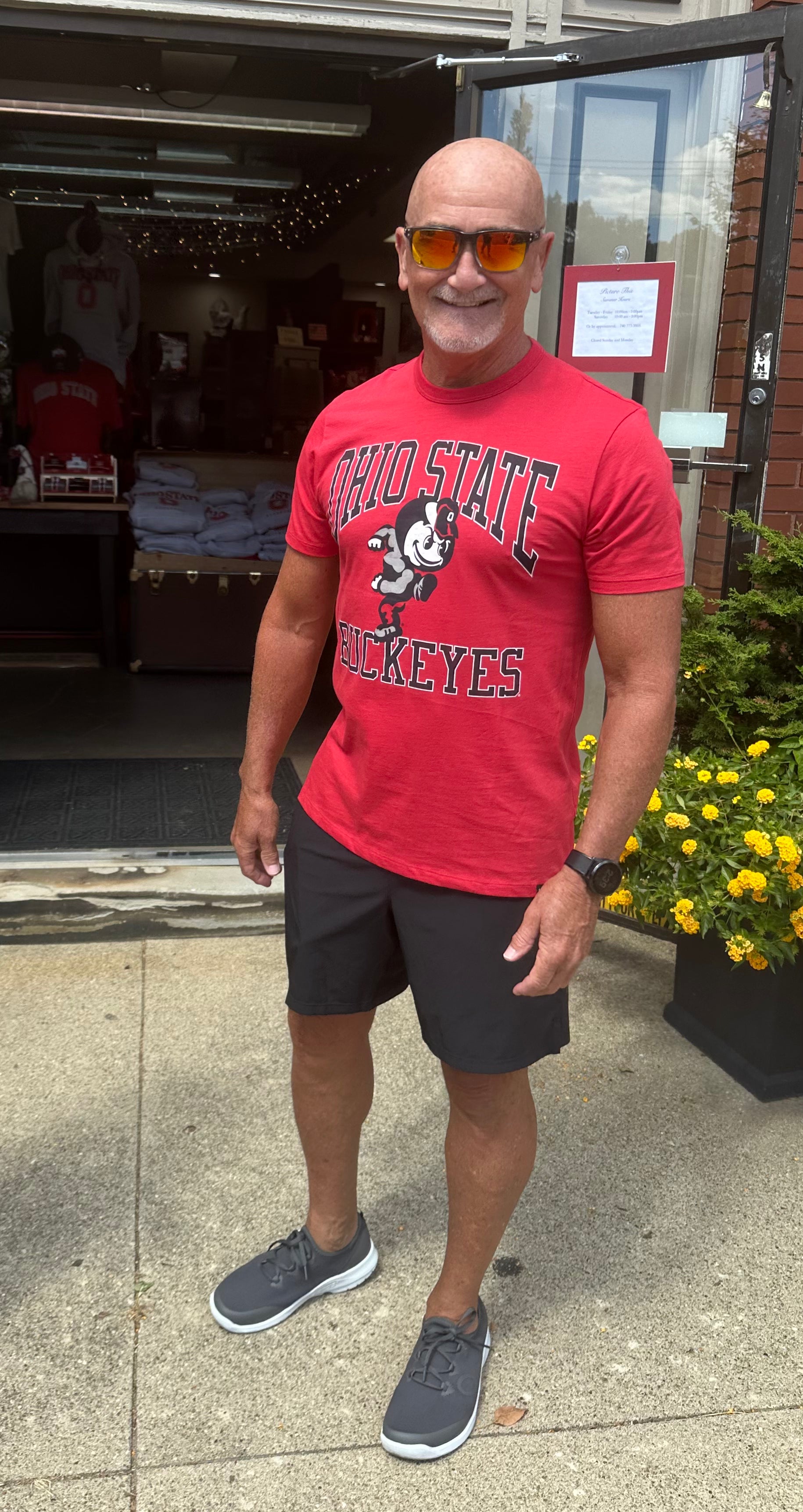 buckeye fan wearing red Ohio State Buckeyes Shirt outside of Store