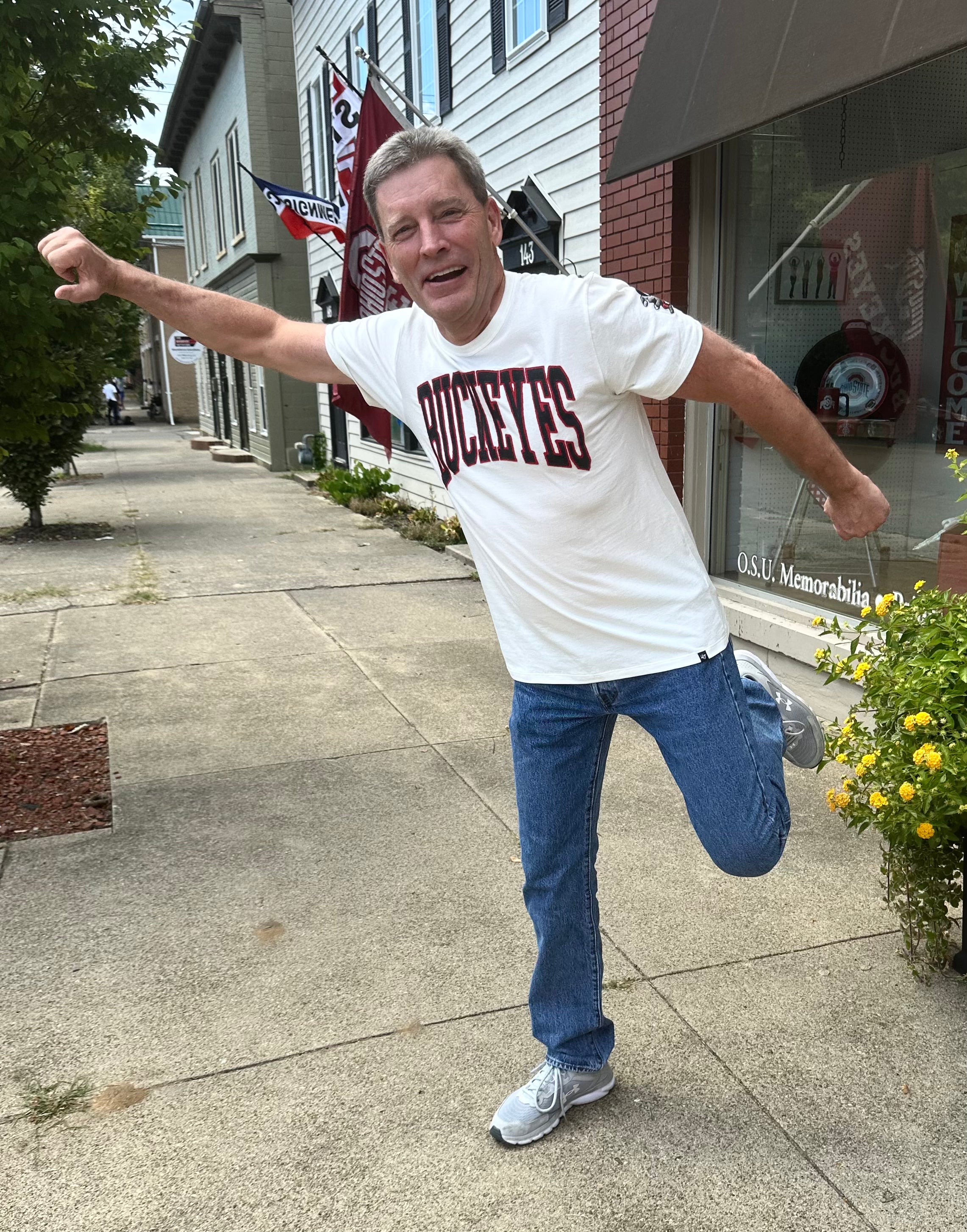 buckeye fan wearing BUCKEYES white shirt outside OSU Sports Fans store
