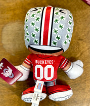 Plush toy with Ohio State Buckeyes uniform on a brown surface