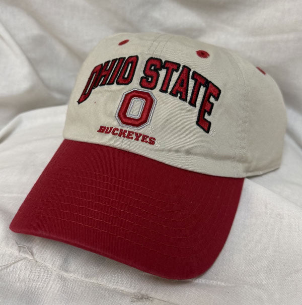 Beige and red Ohio State Buckeyes cap on a white fabric background
