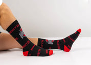 Black socks with red accents and visible branding on a white background