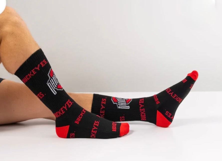 Black socks with red accents and visible branding on a white background