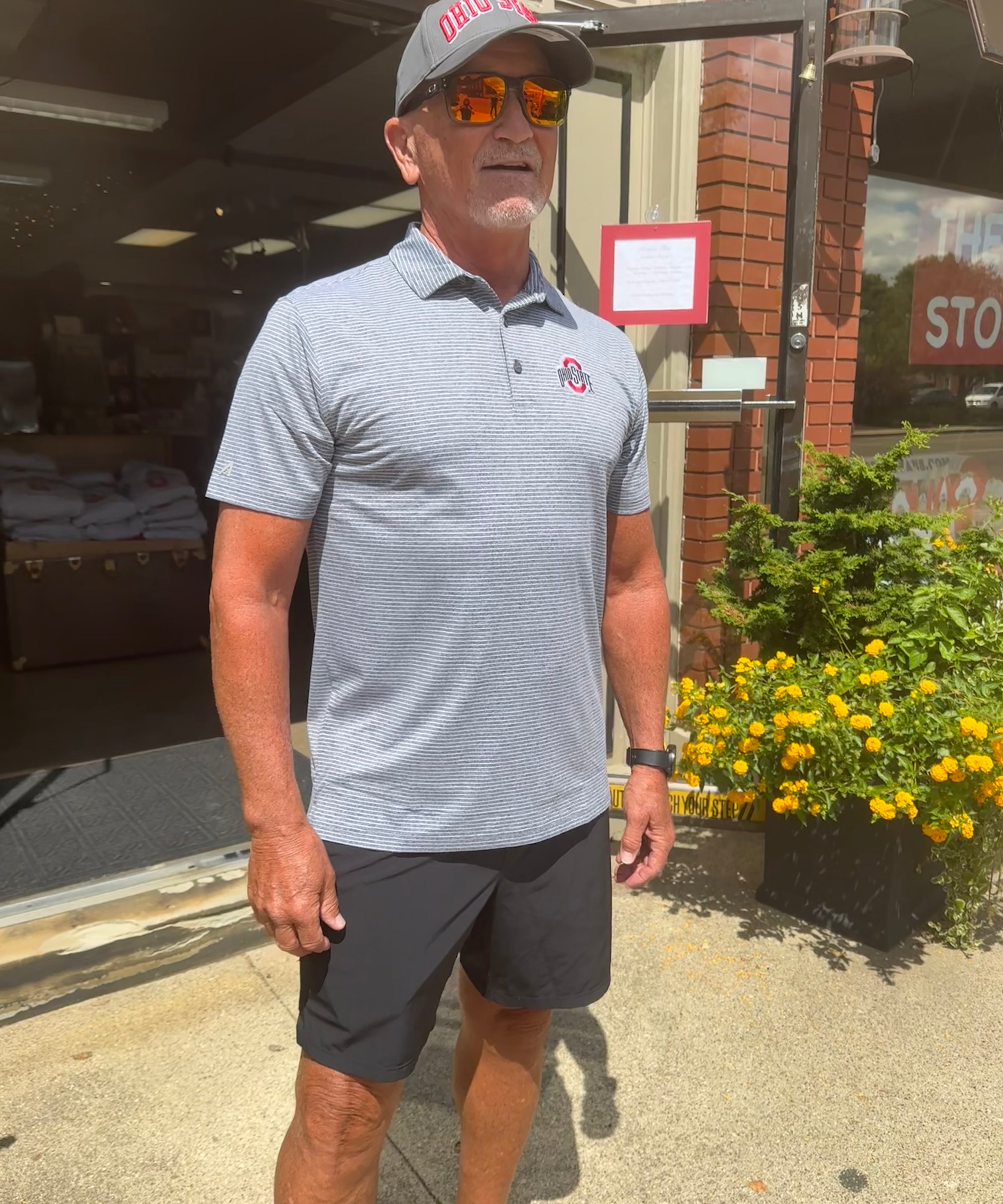 staffers wearing polo shirt outside of store