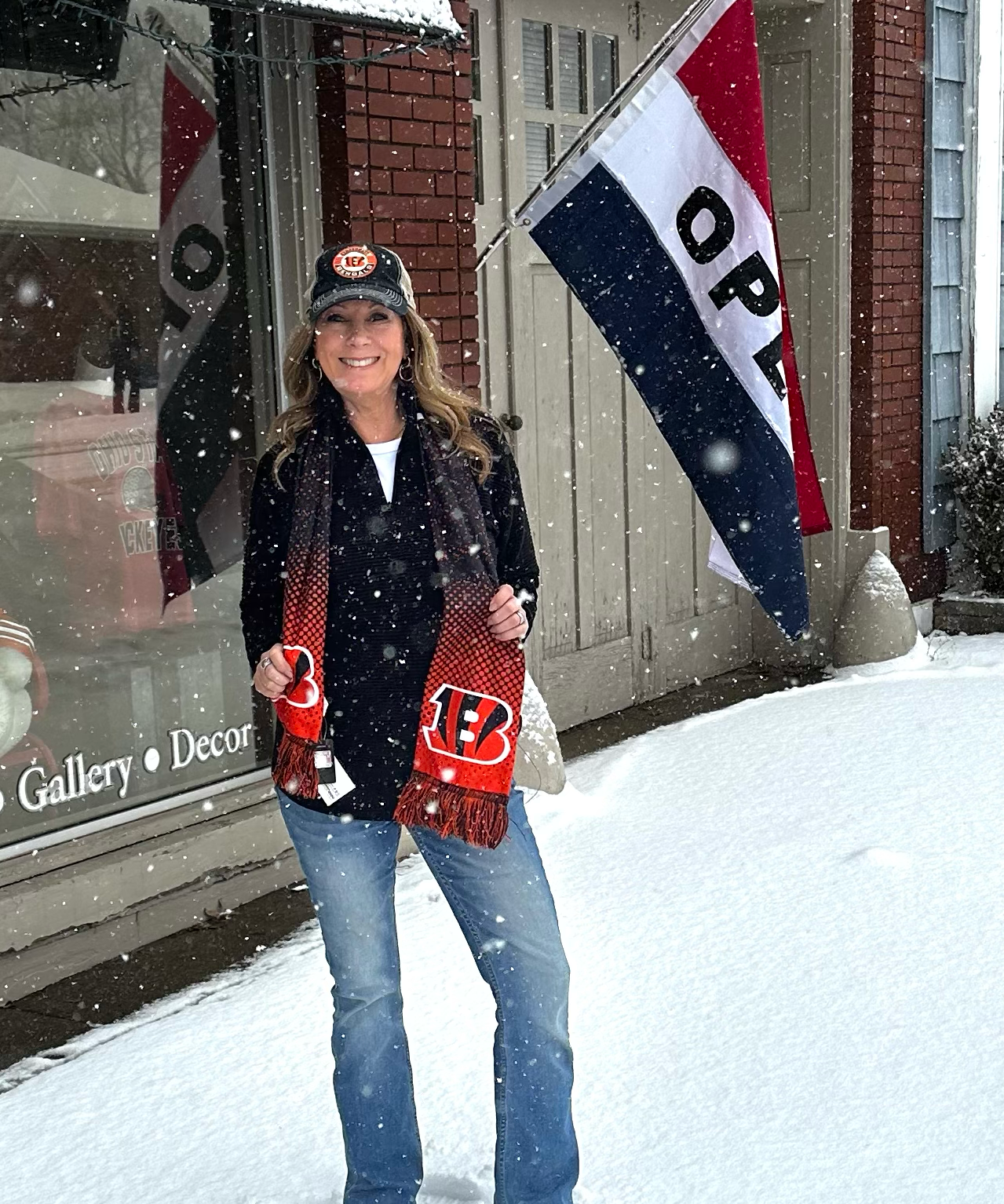 Woman holding sports team merchandise in front of a store with snow on the ground