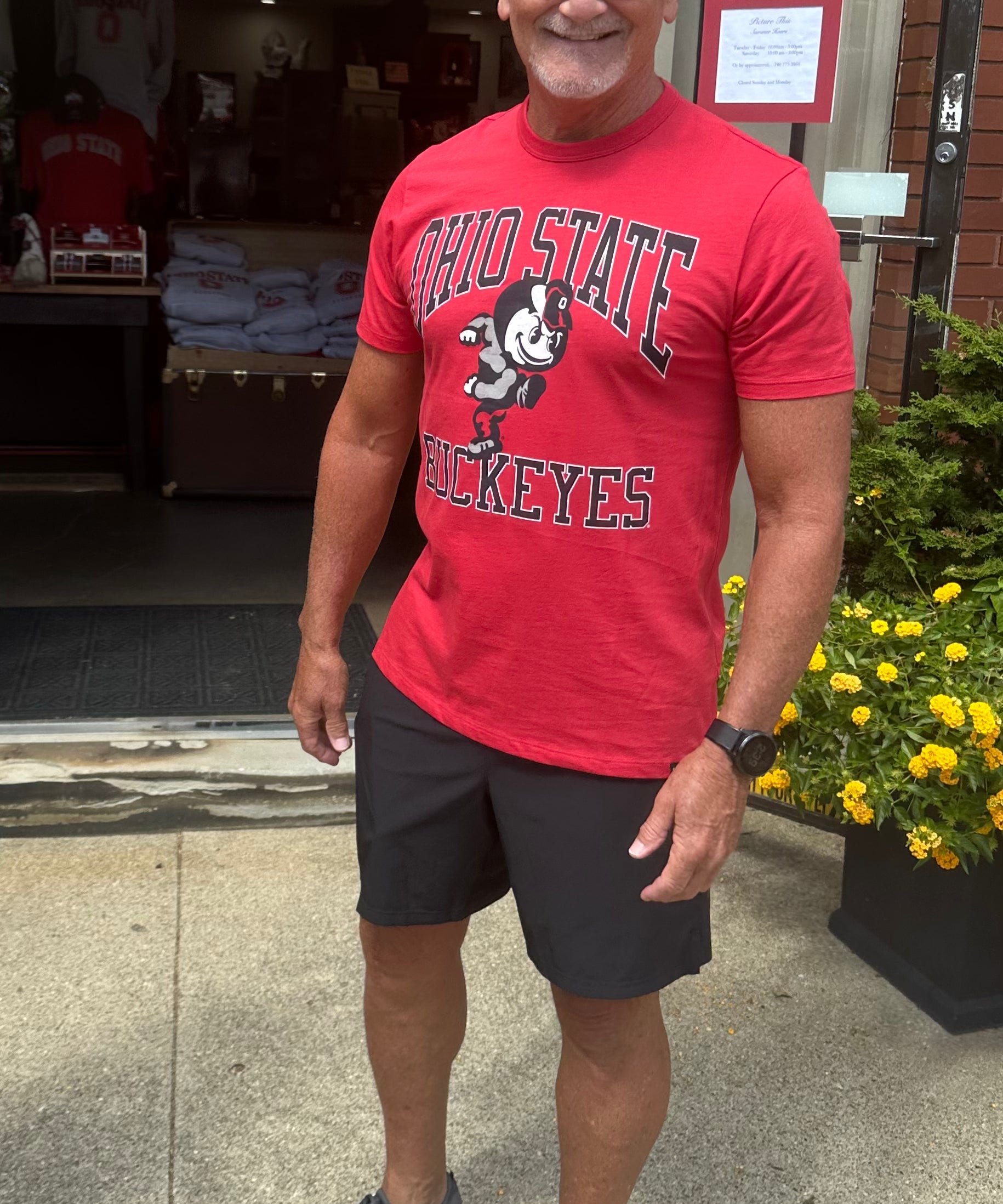 buckeye fan wearing red Ohio State Buckeyes Shirt outside of Store