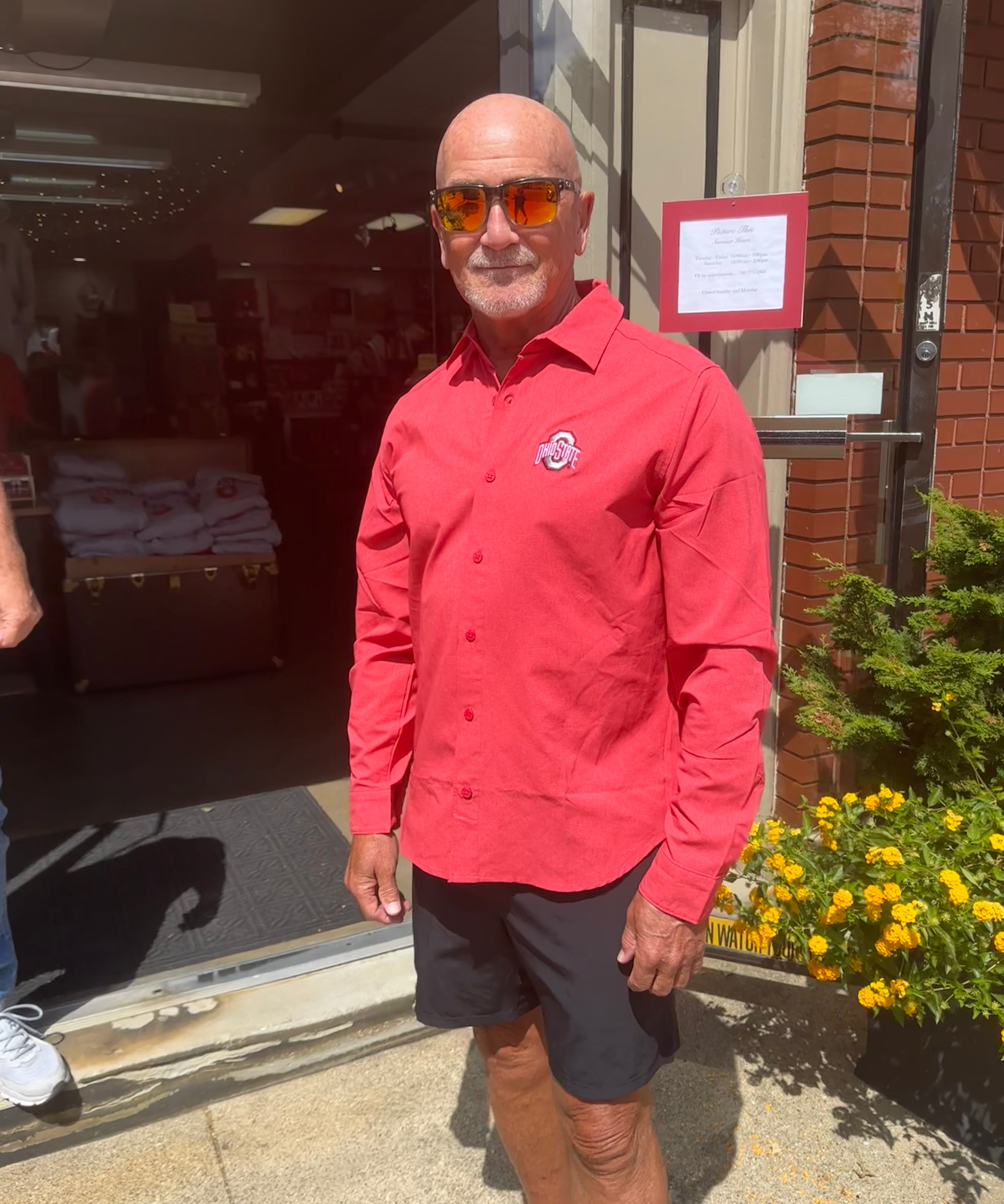 staffer wearing buckeye logo long sleeve shirt, button down