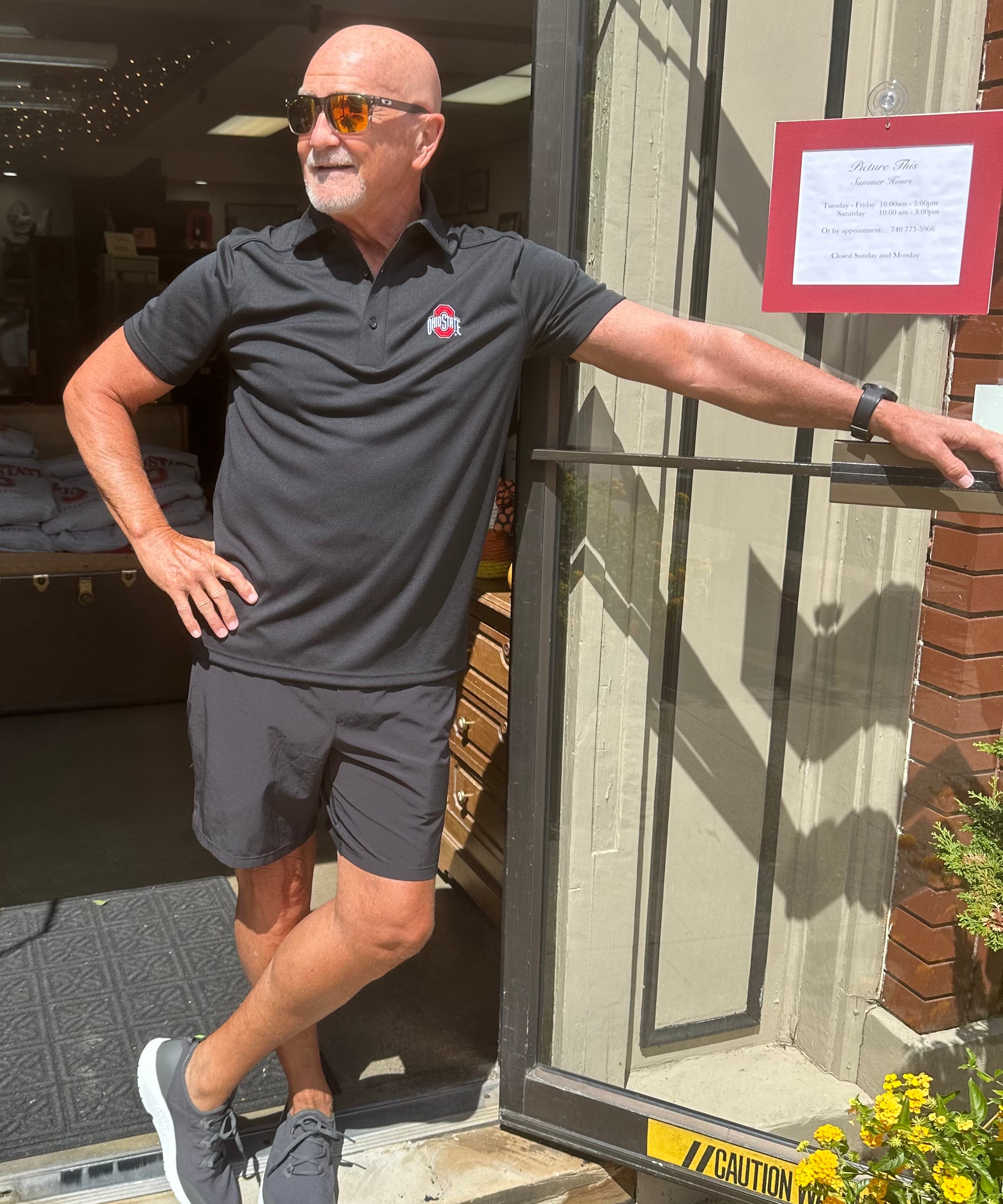 buckeye fan wearing black ohio state logo polo shirt at store