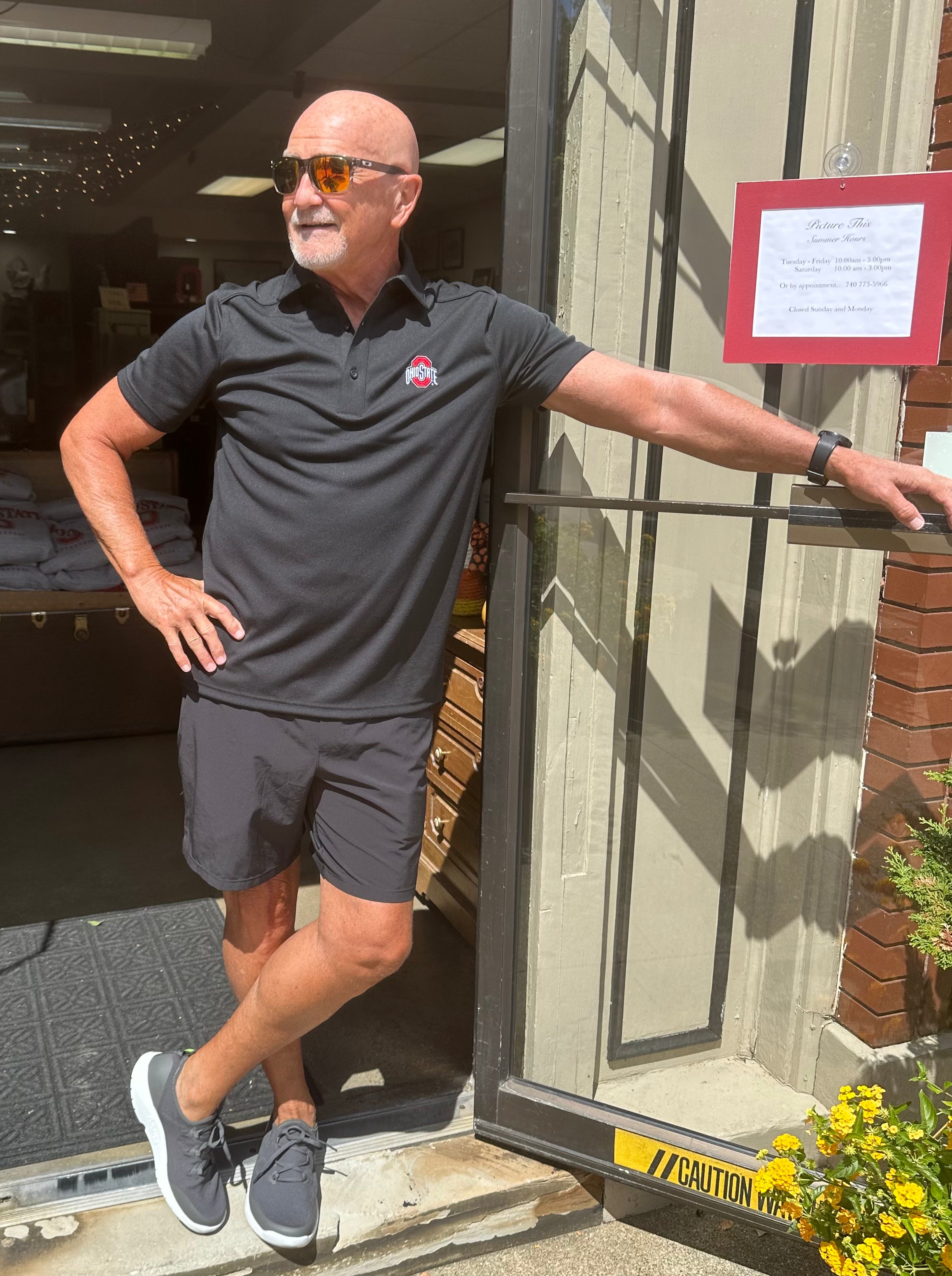 buckeye fan wearing black ohio state logo polo shirt at store