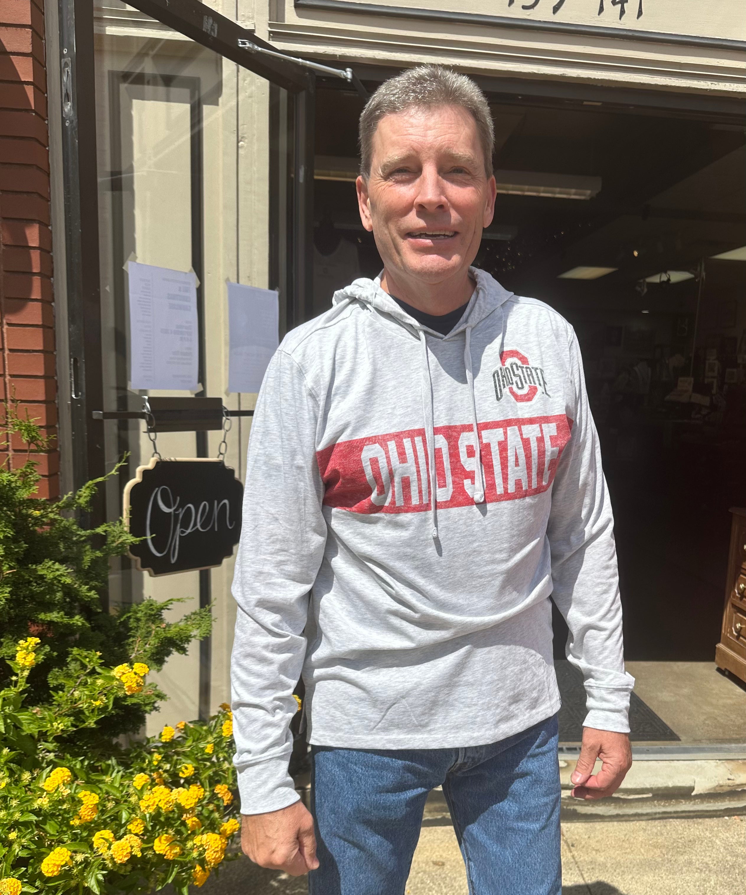 staffer wearing sweatshirt outside store