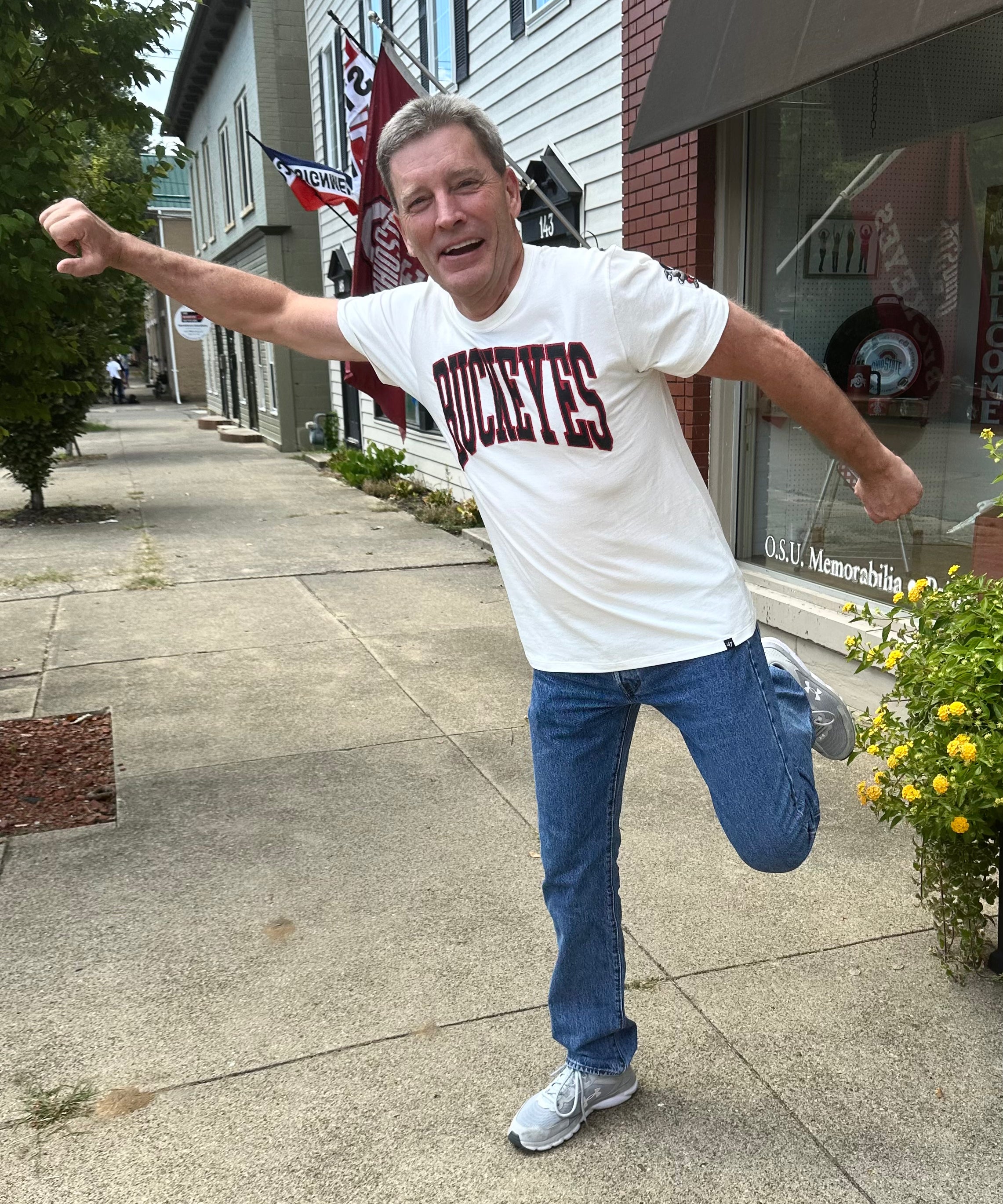 buckeye fan wearing BUCKEYES white shirt outside OSU Sports Fans store