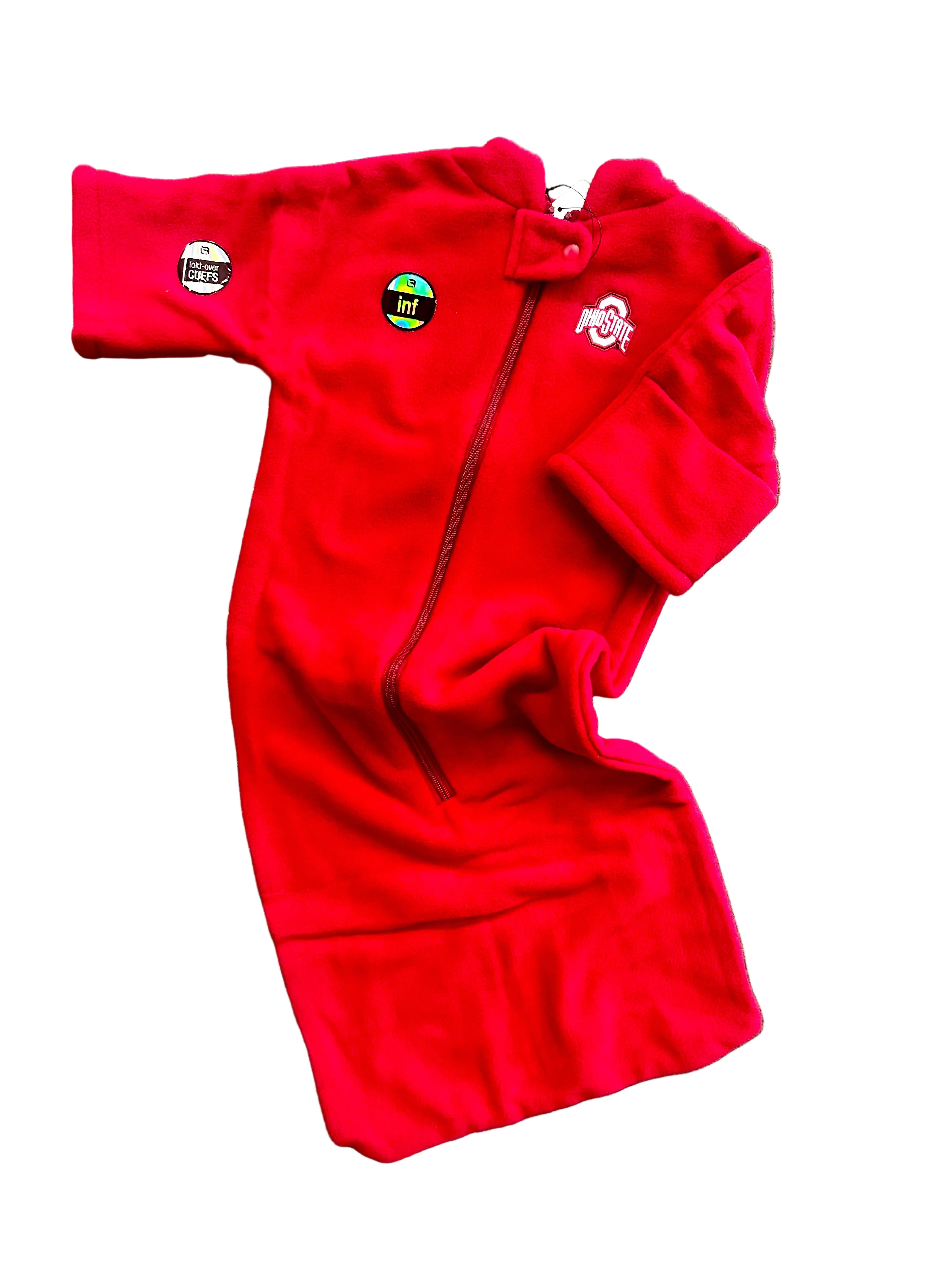 Red fleece blanket with logos on a gray surface