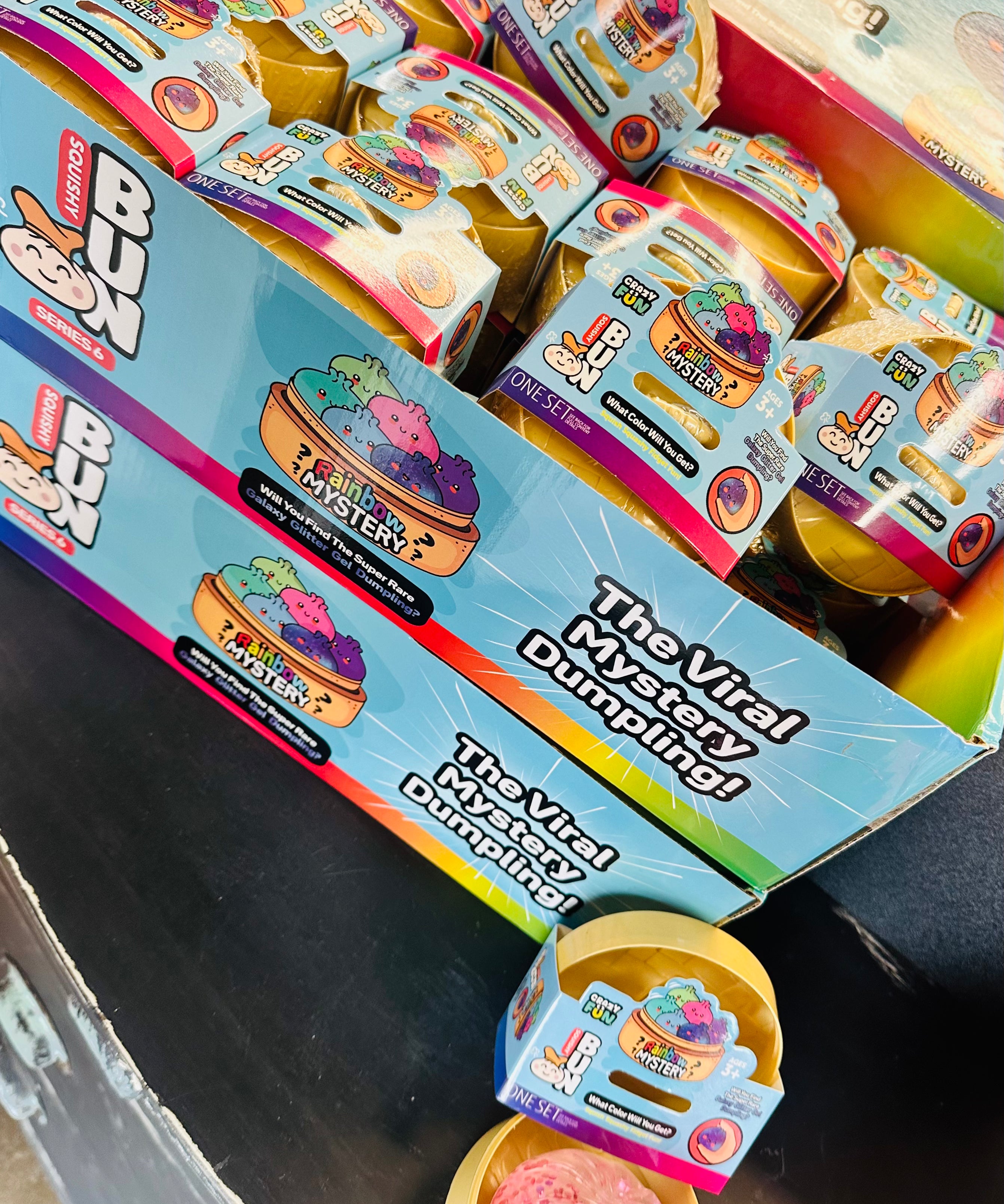 Box of 'The Viral Dumpling' toy with colorful packaging on a dark surface