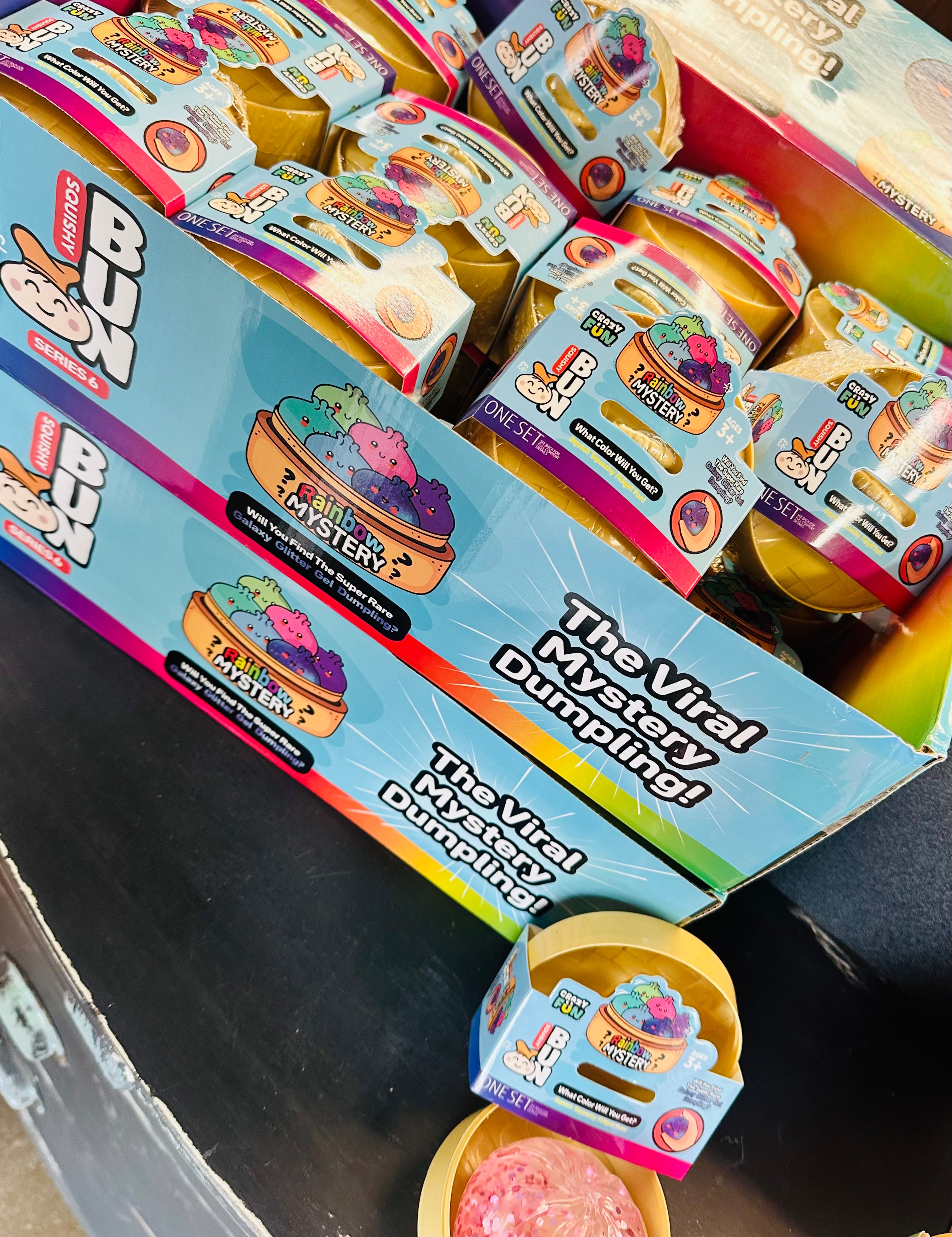 Box of 'The Viral Dumpling' toy with colorful packaging on a dark surface