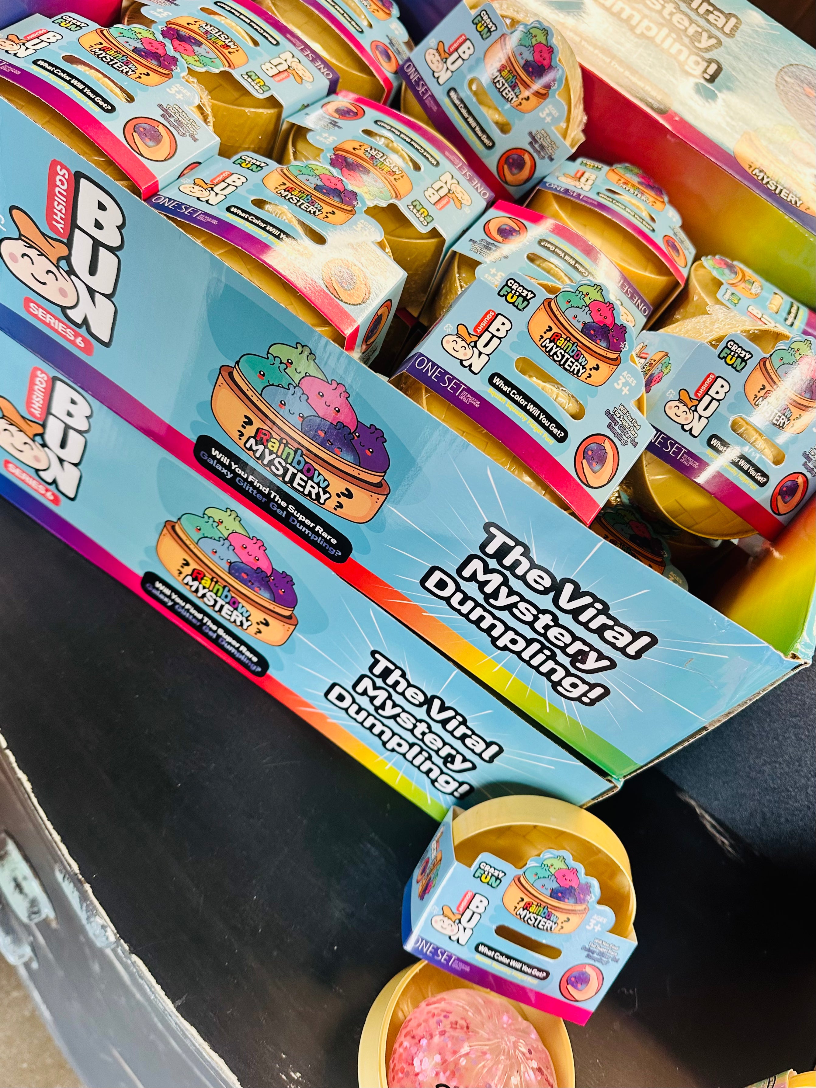 Box of 'The Viral Dumpling' toy with colorful packaging on a dark surface