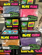 Multiple packages of 'Nice Cube' stress balls on a shelf with colorful packaging.