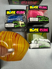 Colorful squishy cubes with packaging labeled 'Nice Cube' on a gray surface.
