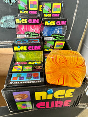 Display of 'Nice Cube' stress relief products with a colorful cube in front.