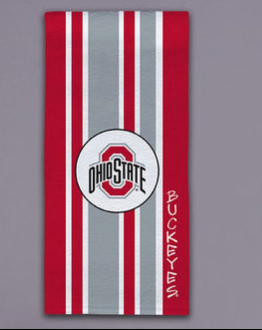 A vertical Ohio State Buckeyes themed towel featuring red and gray vertical stripes, a central circular logo with the Ohio State 'O' and text, and the word 'BUCKEYS' printed vertically on the right side, shown against a solid gray background.