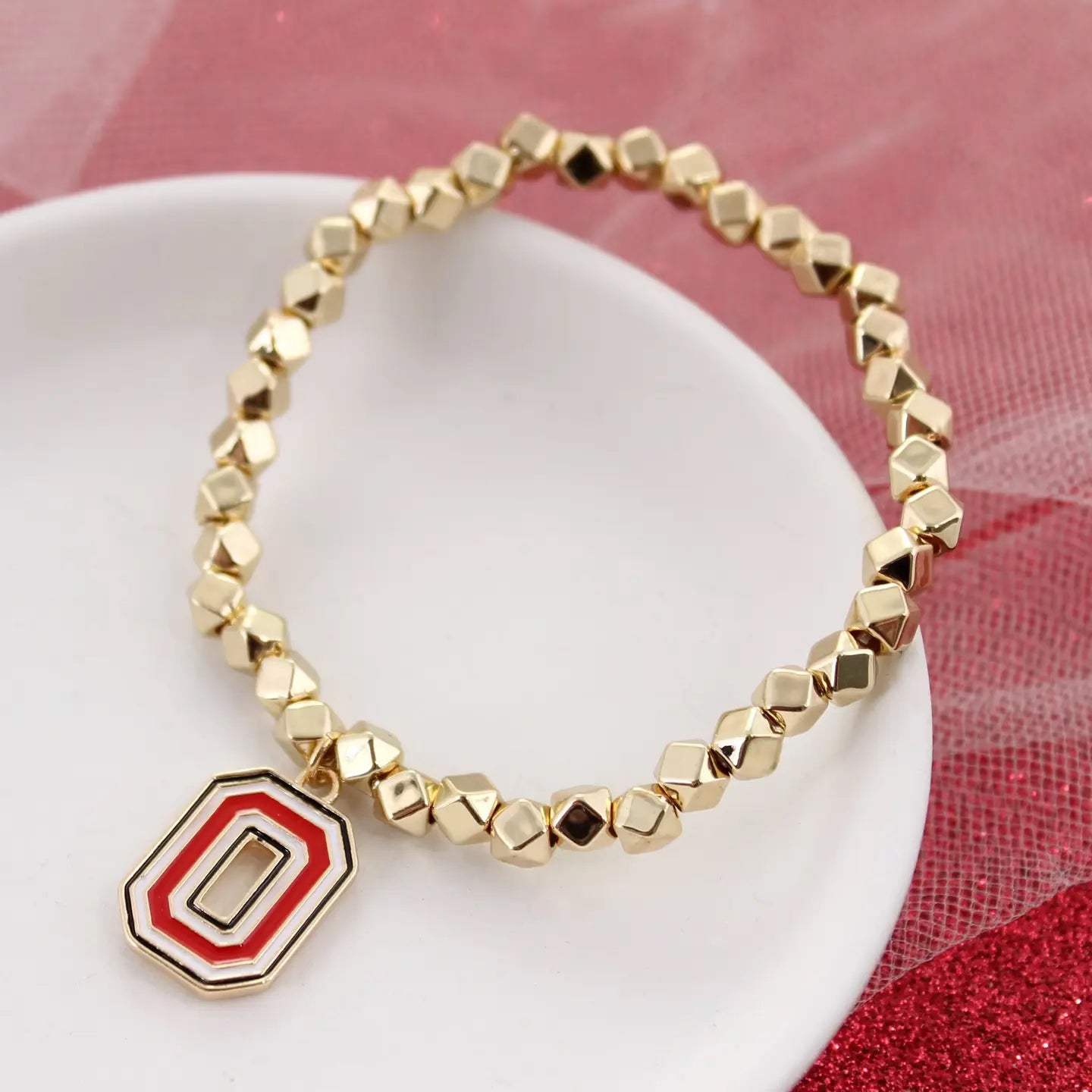 Ohio State gold stretch bracelet with beaded design and enamel logo charm