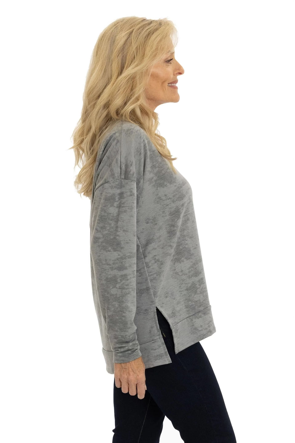 Woman wearing a gray long-sleeve top on a white background