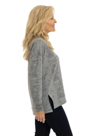 Woman wearing a gray long-sleeve top on a white background