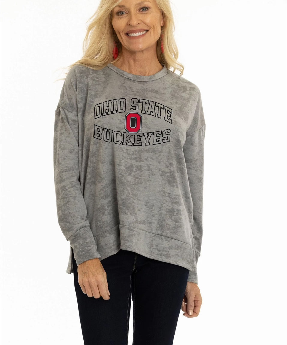 Woman wearing a gray 'Ohio State Buckeyes' sweatshirt on a white background