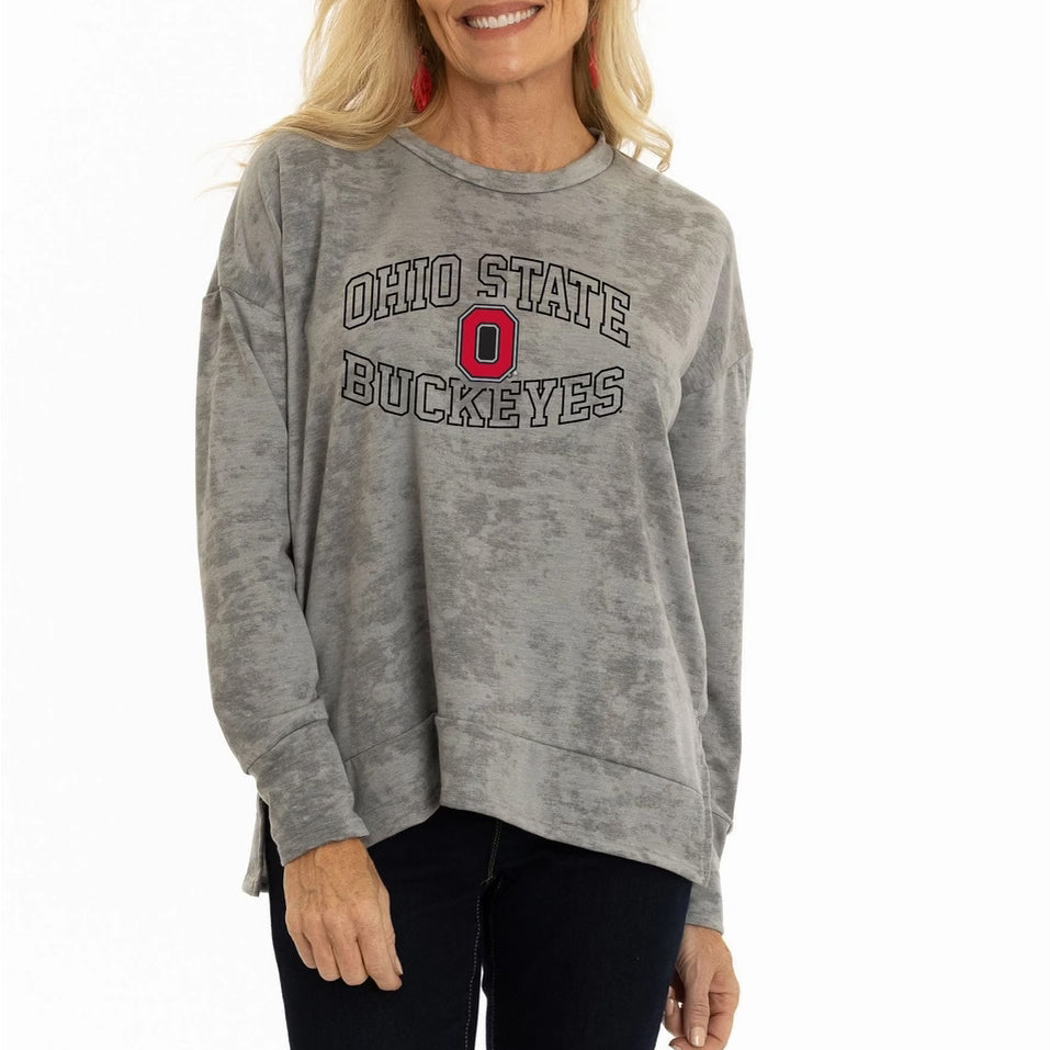Woman wearing a gray 'Ohio State Buckeyes' sweatshirt on a white background
