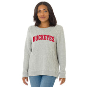 Woman wearing a gray sweatshirt with 'Buckeyes' printed in red on a white background