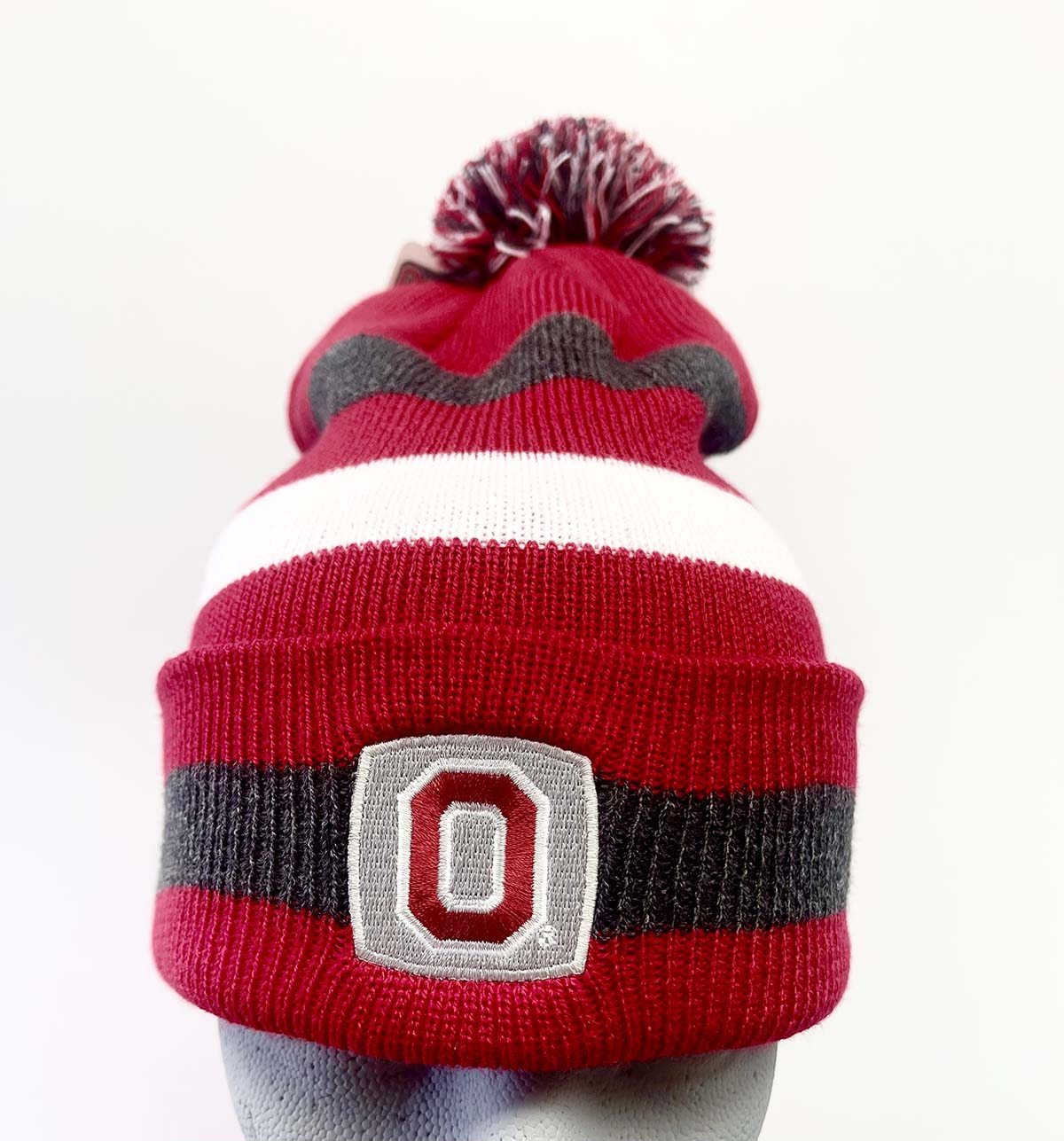 Striped knit cuff hat with Pom and Stitched Block O logo